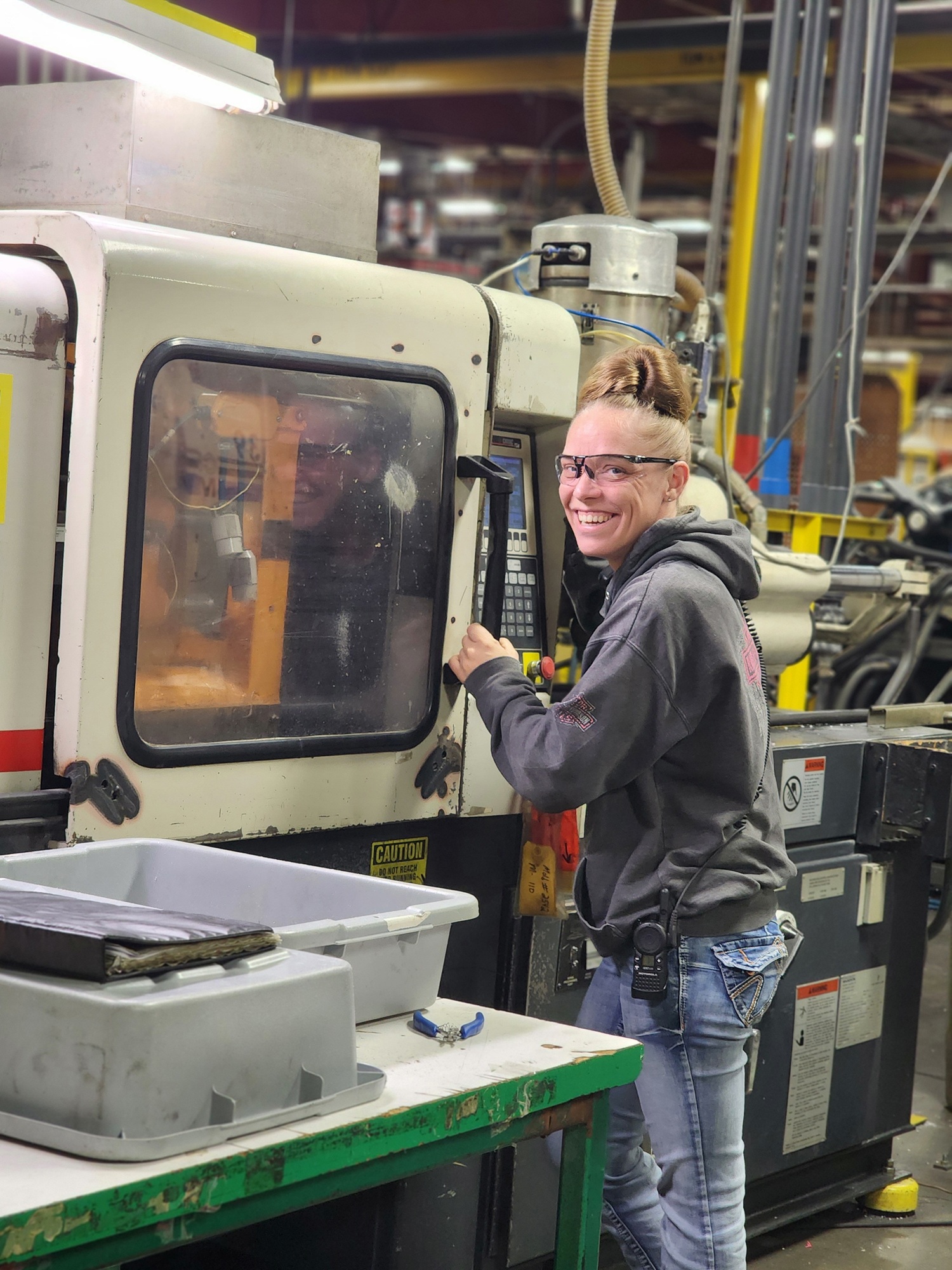 woman standing next to machine